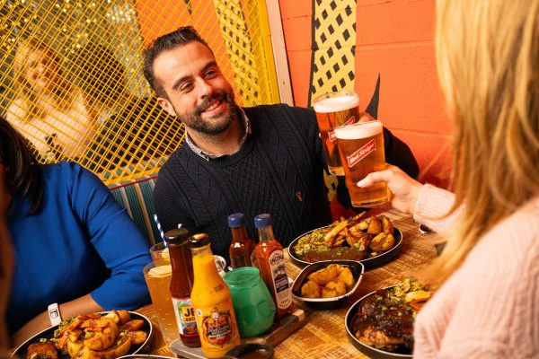 Reggae Roast Red Stripe cheers over food man in 40s 2